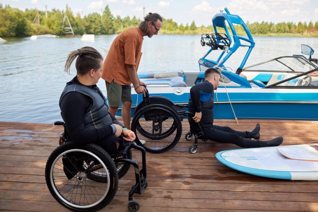 Two people with disability using adaptive sports equipment on lake